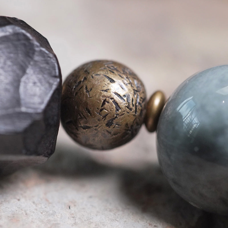 Paararmband aus Adlerauge-Stein mit Ebenholz und Kupfer