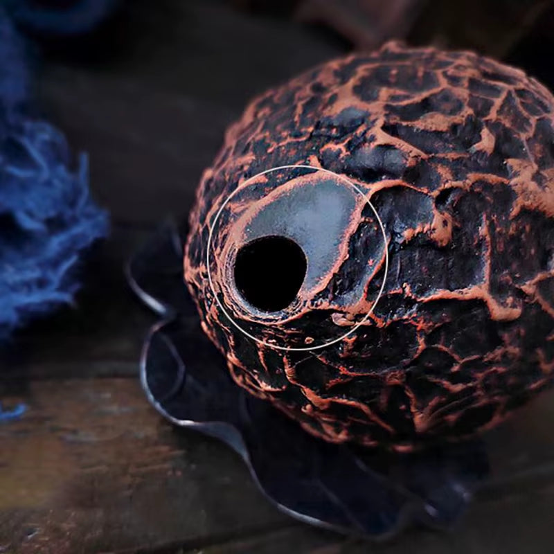 Textured copper-colored sphere with hole for the 10-Hole Pottery Xun musical instrument