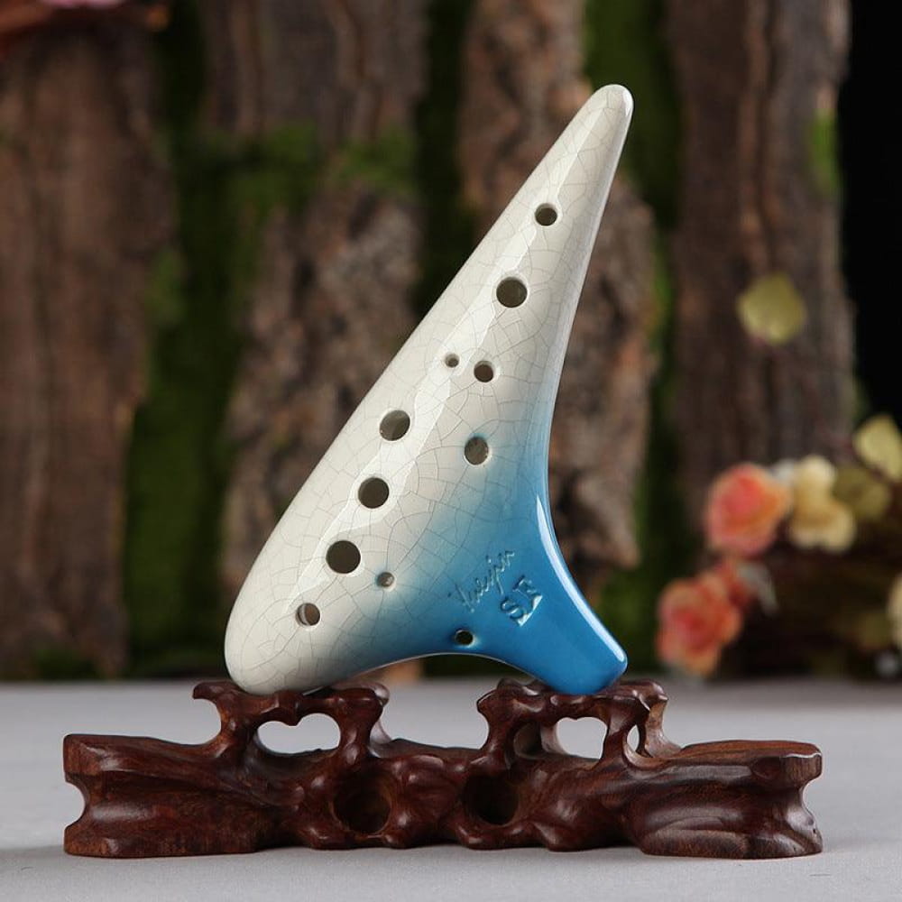 White and blue ceramic 12 Hole Soprano Treble Ocarina on decorative brown stand
