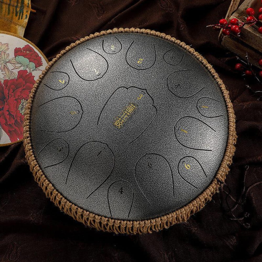 13-Inch Carbon Steel Tongue Drum with circular tone pads and woven rope border
