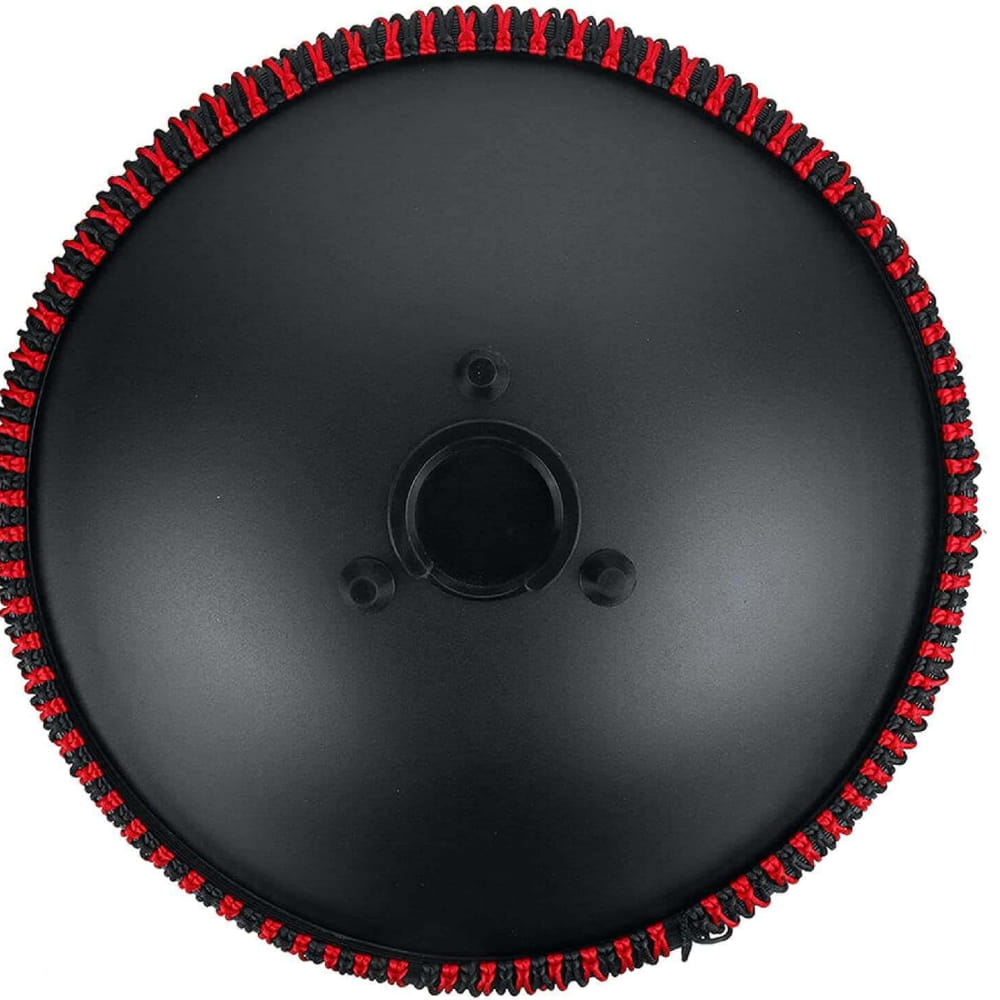 Black circular disc with red and black notched edges on 14 Inch 9 Note D Minor Tongue Drum