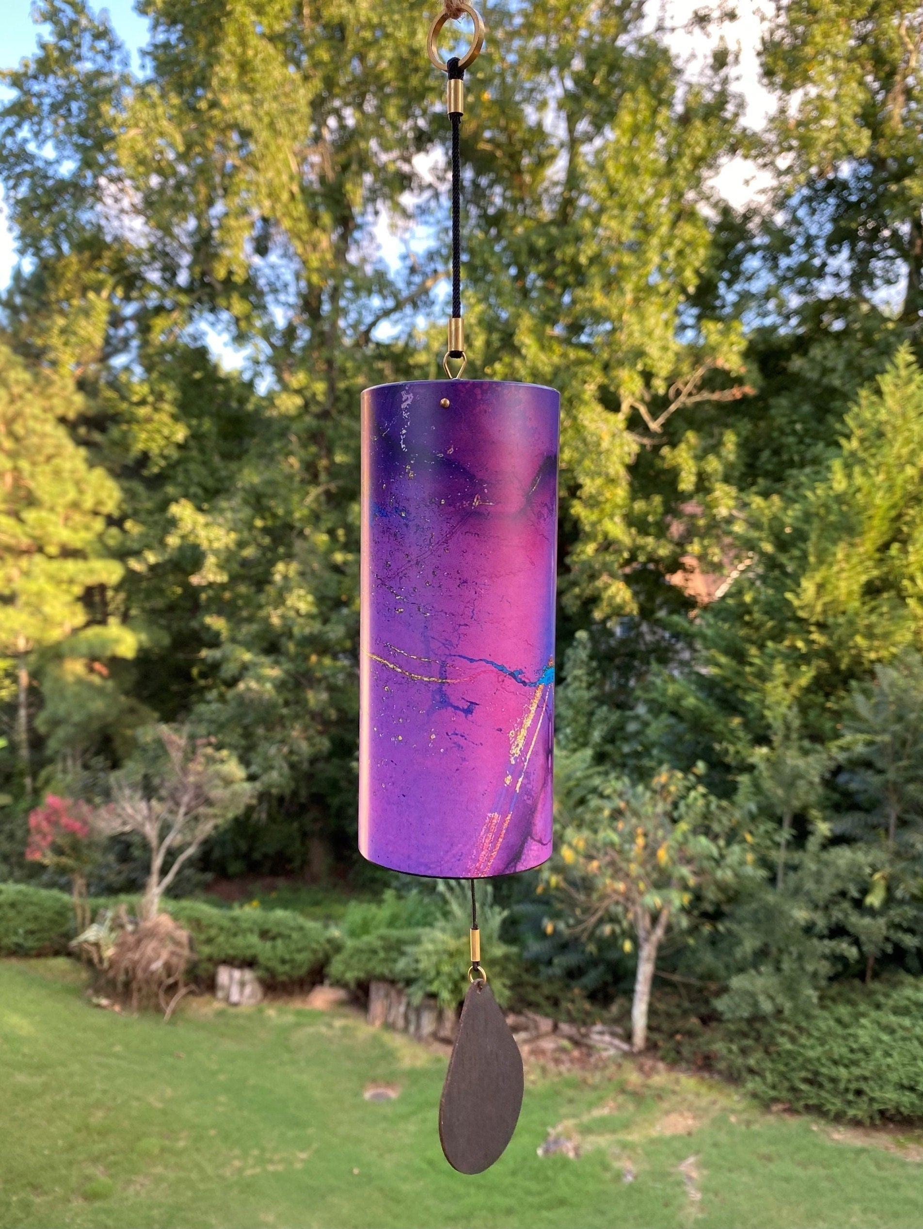 Purple metallic wind chime with a paddle for home and garden relaxation decor