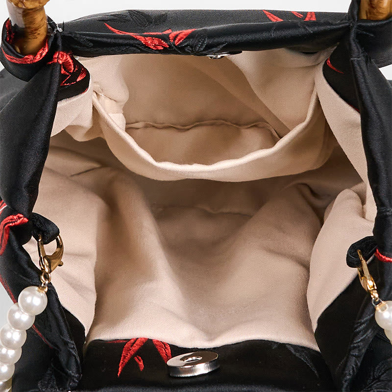 Schwarze Tasche aus Polyester-Baumwolle mit bestickten Blättern und Bambusgriff