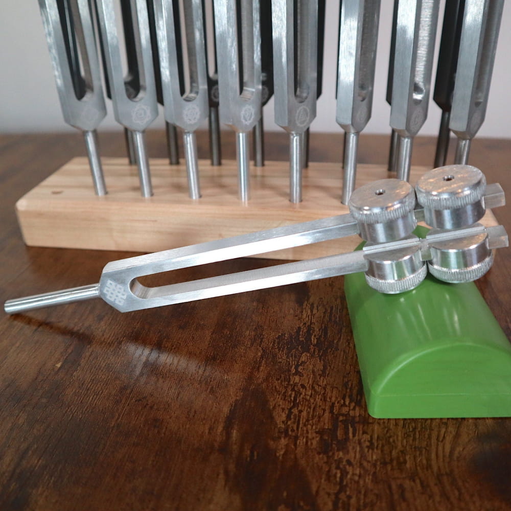 Tuning fork with green base holder from 18pc Tuning Fork Set for Chakra Frequencies