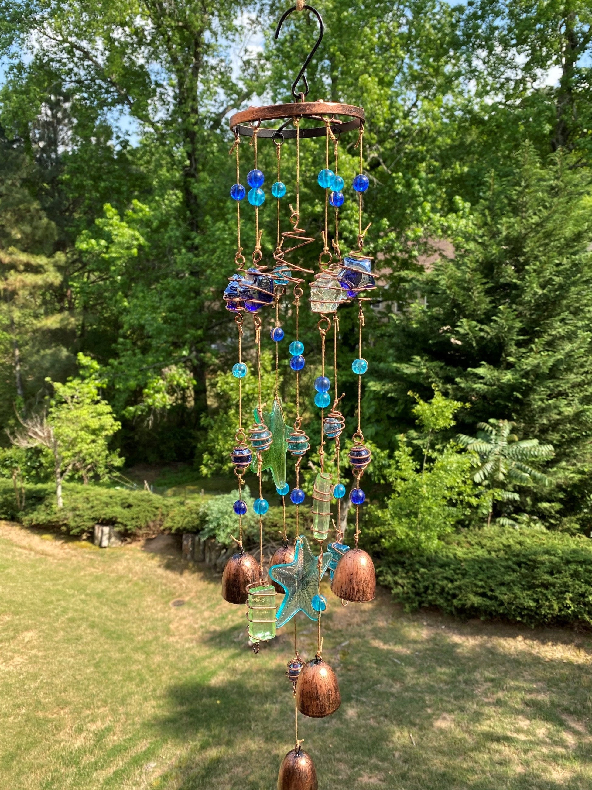 Decorative wind chime with blue glass balls, copper bells, and butterfly ornaments