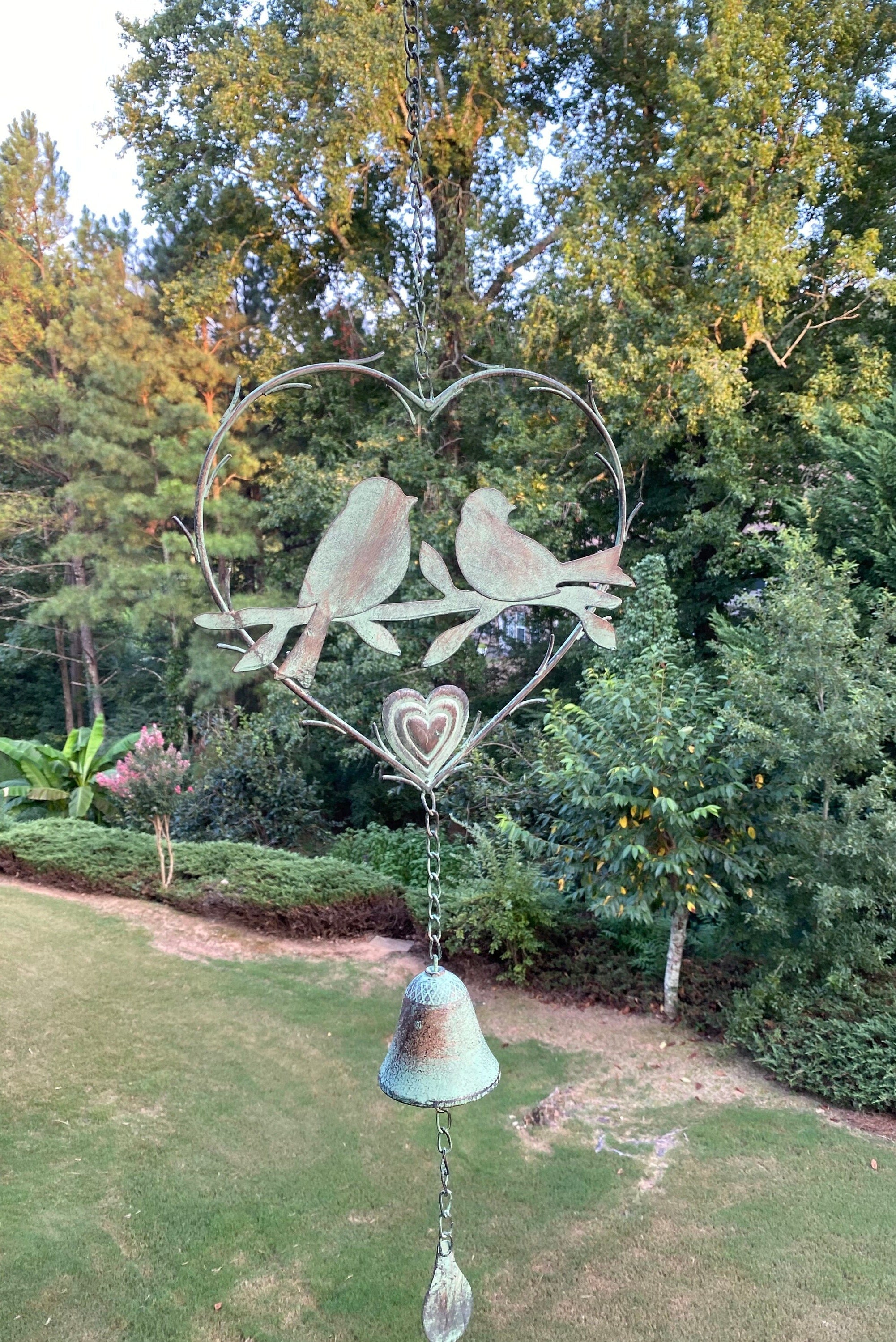 Metal wind chime with birds in heart shape, bell, and crystal pendant for memorial decor