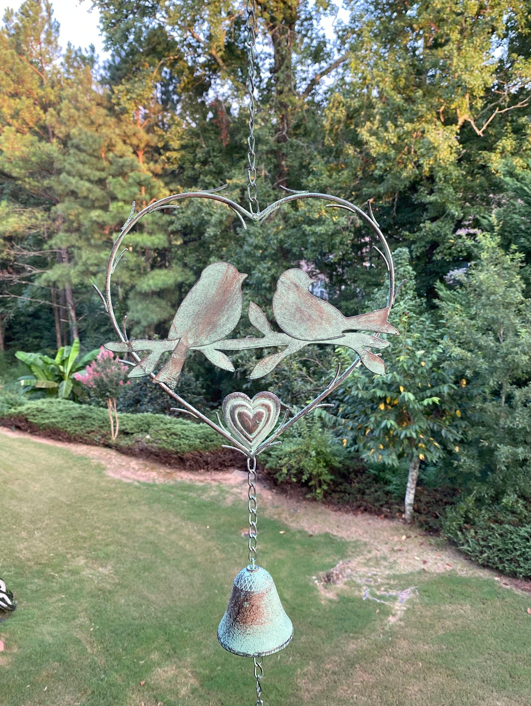 Metal garden ornament of birds on a heart frame with bell in Elegant Memorial Wind Chime