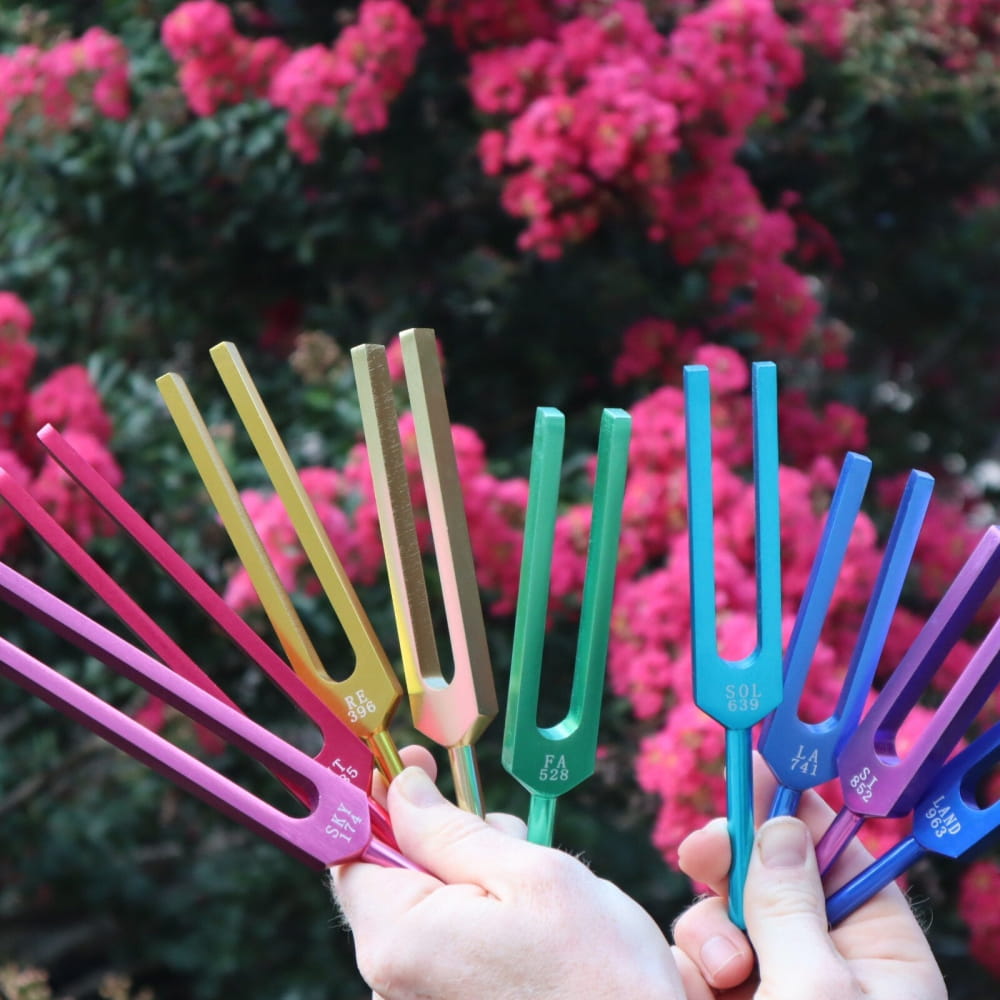 Colorful tuning forks in a rainbow pattern for healing and sound therapy