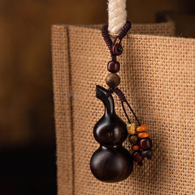 Schlüsselanhänger aus Kürbis aus Ebenholz und rotem Sandelholz für Glück und Schutz