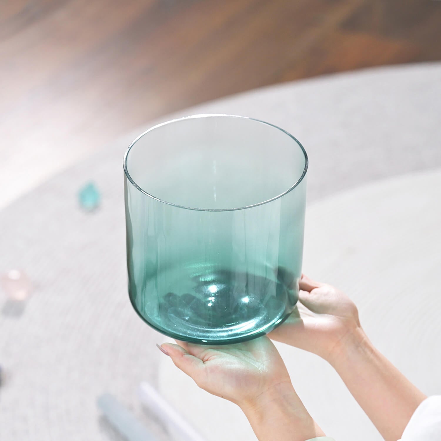 Teal glass drinking vessel with a cylindrical shape for holistic meditation healing