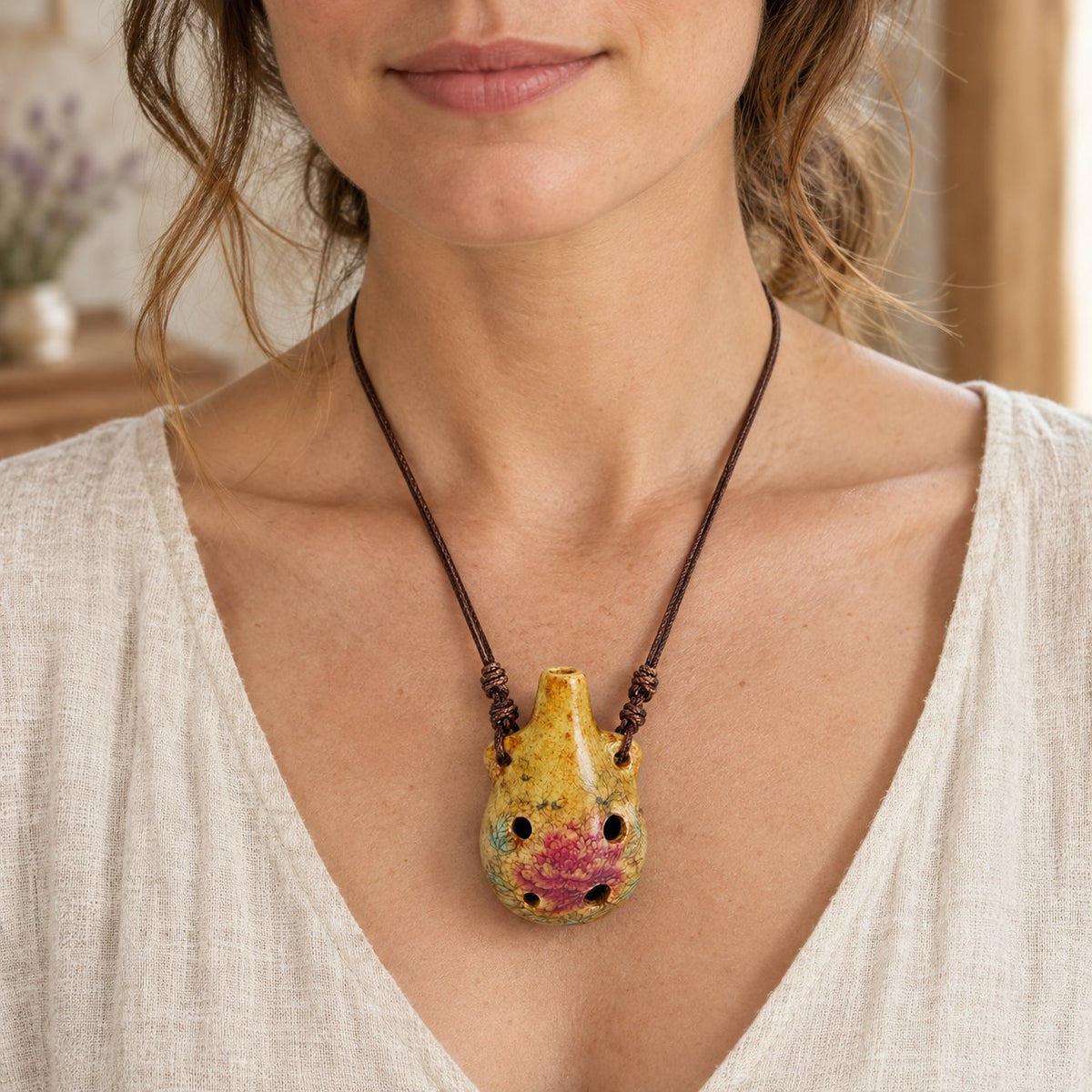 Beginner's 6-Hole Alto C Ocarina Pendant, worn on the neck by a woman
