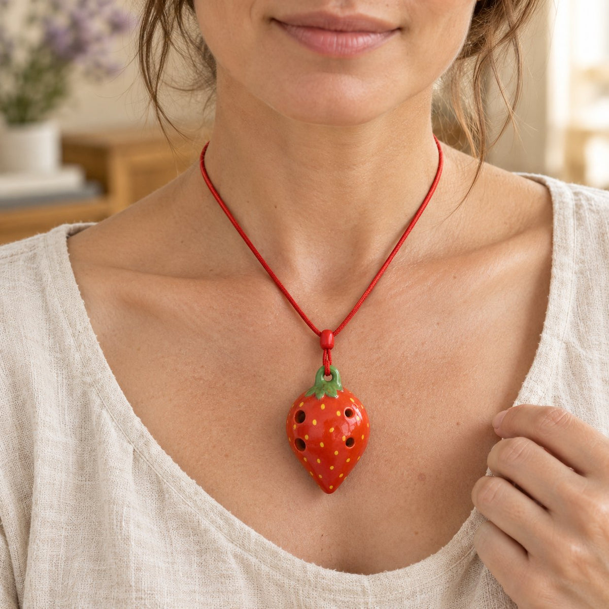 6 Hole Strawberry Ocarina Pendant for Beginners, worn on the neck by a woman