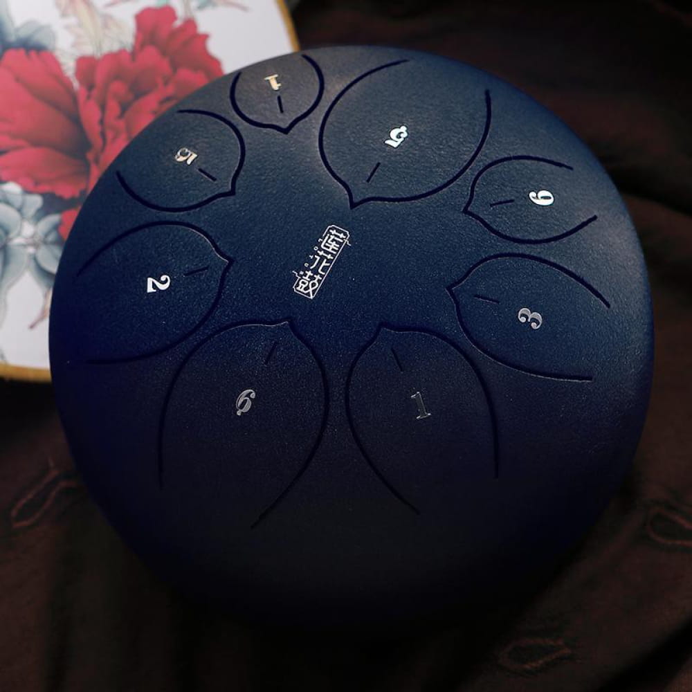 Navy blue steel tongue drum in F key with 8 tones, numbered sections in a circle