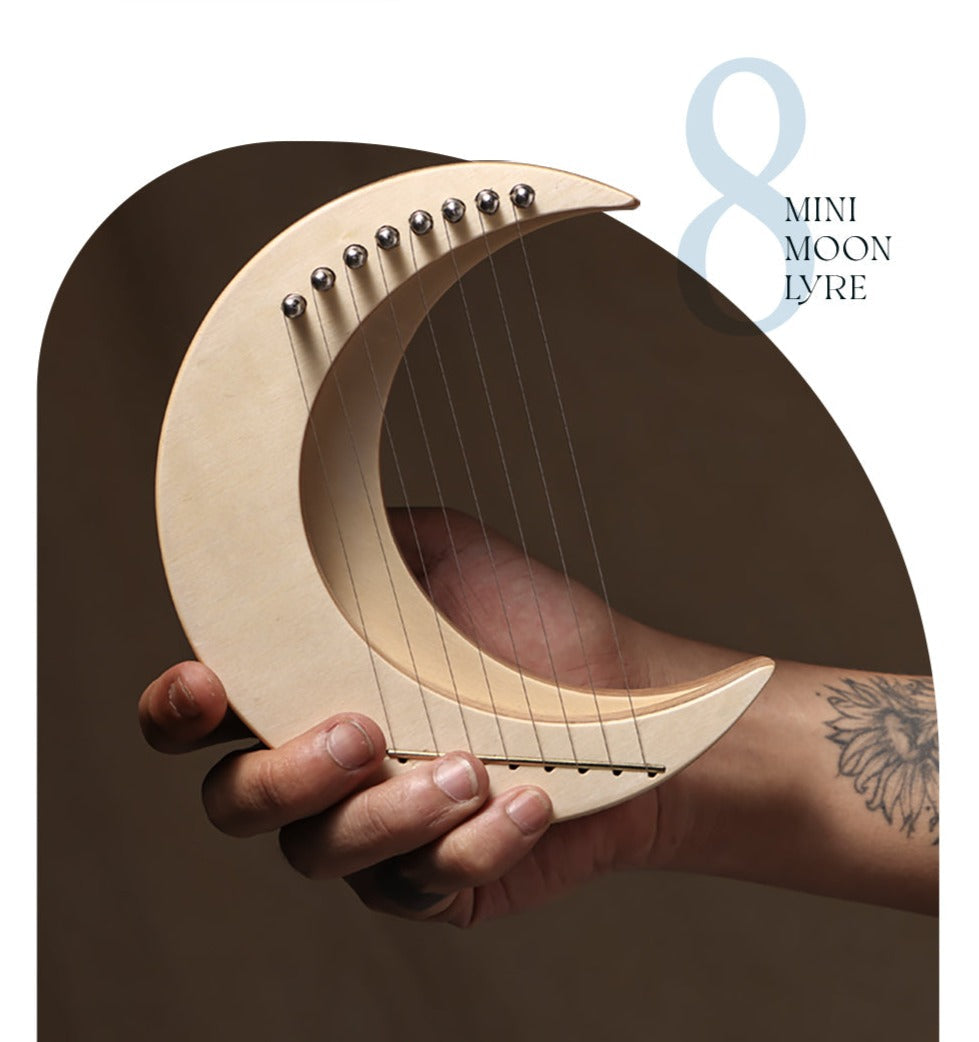 Crescent moon-shaped 8-string mini lyre harp instrument with strings