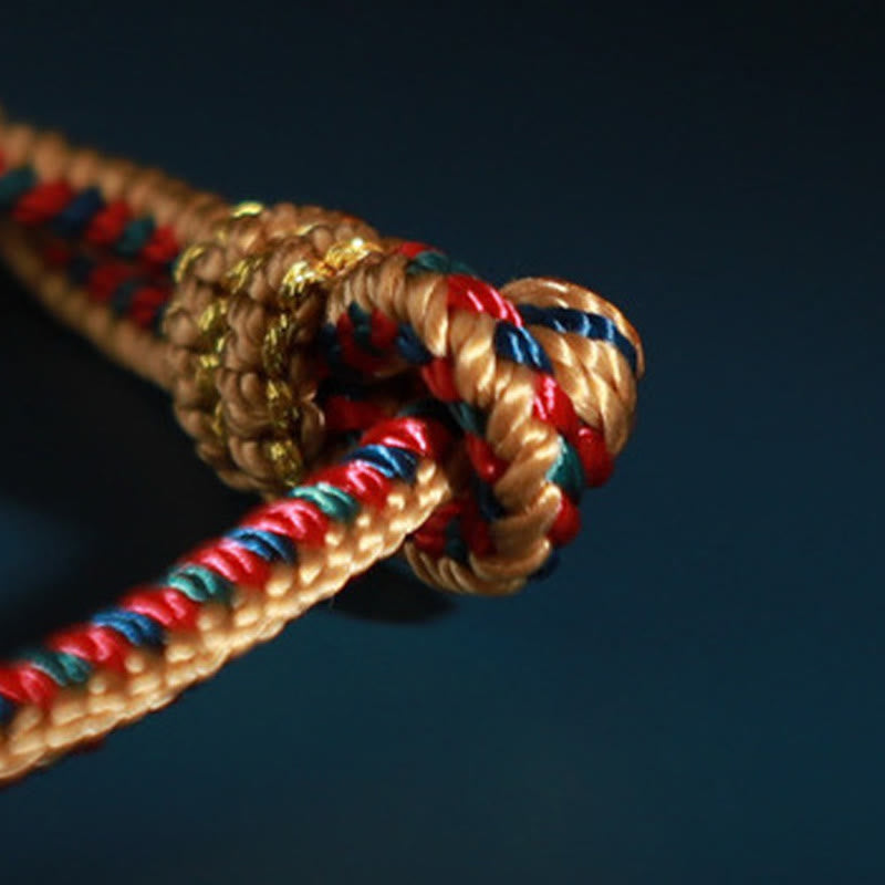 Handgefertigtes tibetisches Schutzarmband mit roter Schnur