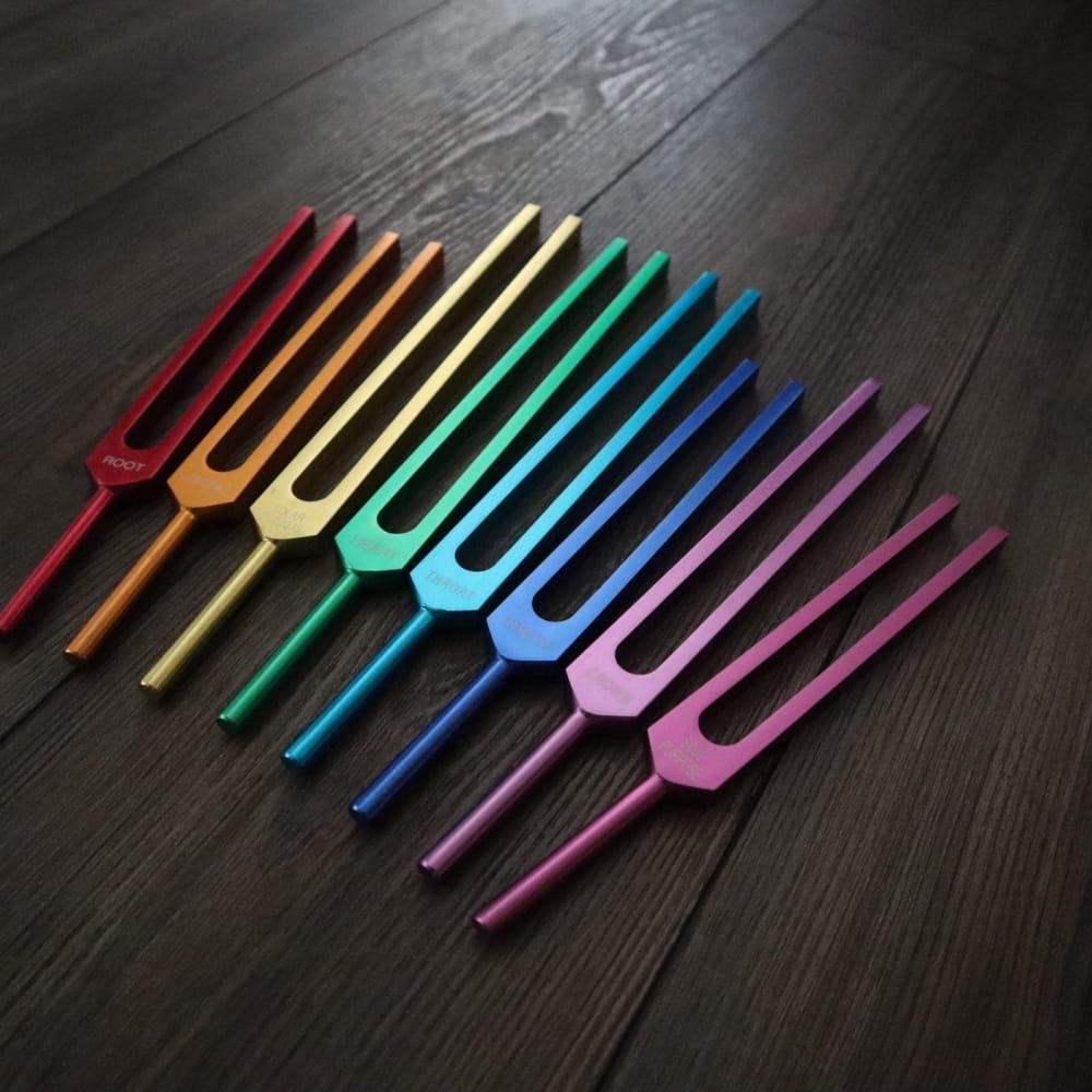 Rainbow-colored tuning forks in a row for Chakra healing and BioField therapy