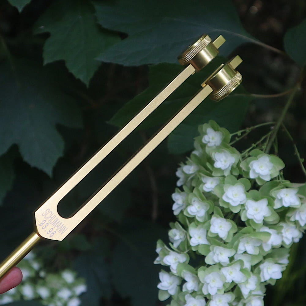 Golden tuning fork with metallic finish for 93.96 Hz sound healing and energy work