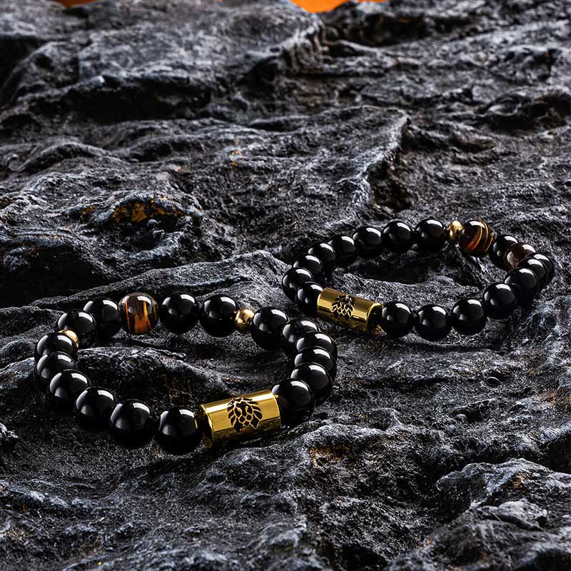 Schwarzes Onyx-Tigerauge-Schutzarmband mit Löwenperle