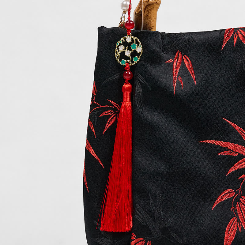 Schwarze Tasche aus Polyester-Baumwolle mit bestickten Blättern und Bambusgriff