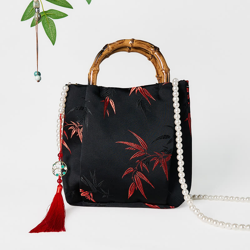 Schwarze Tasche aus Polyester-Baumwolle mit bestickten Blättern und Bambusgriff