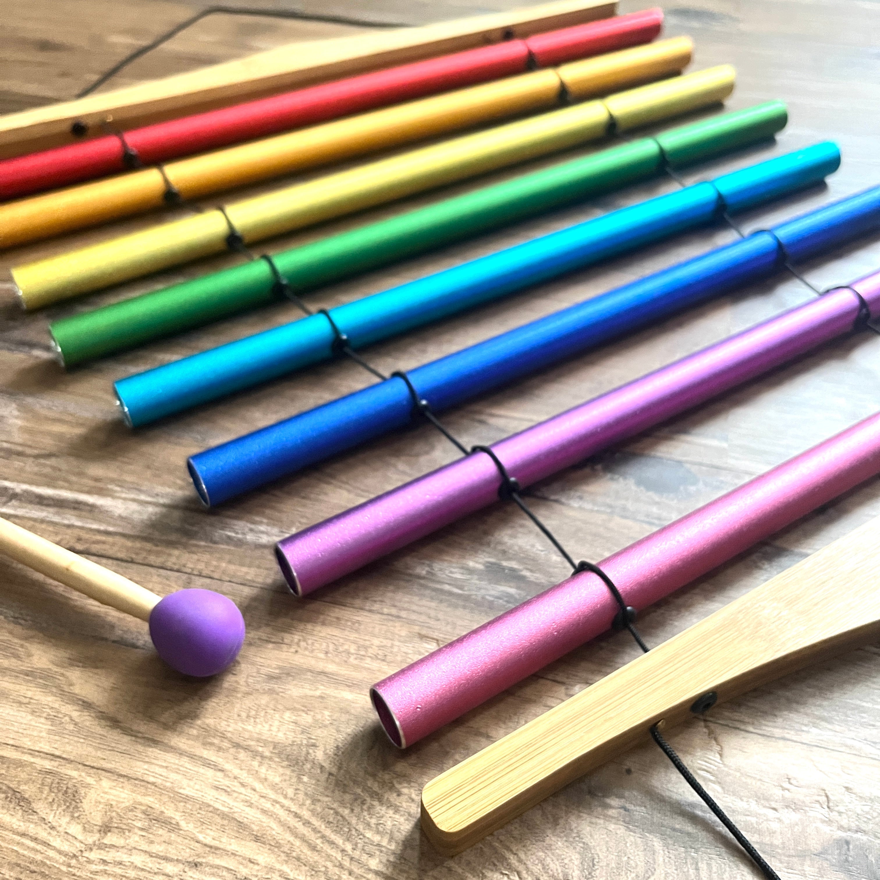 Rainbow-colored felt-tip markers arranged in a row for Chakra Schumann Swinging Chimes