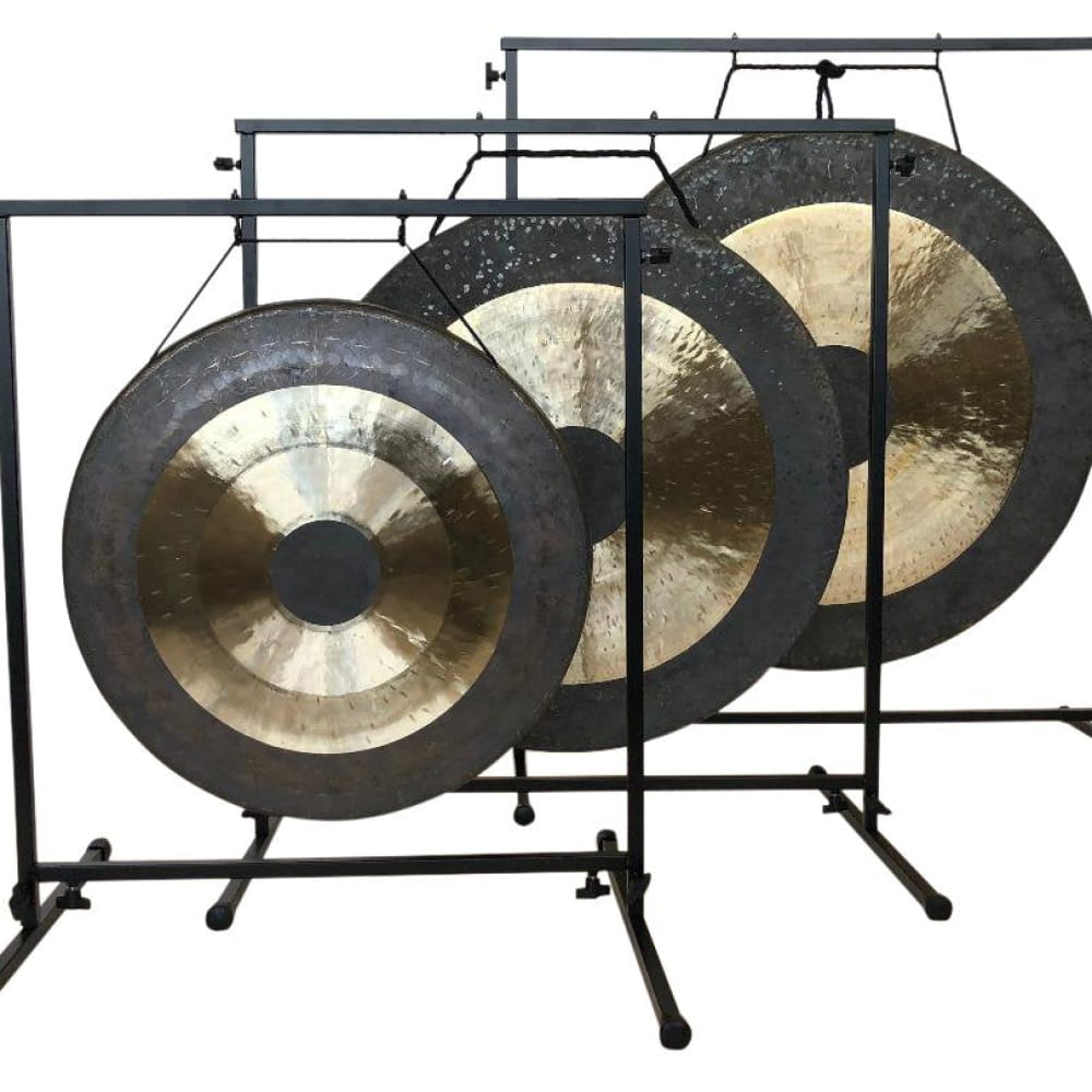 Three gongs on metal stands for enhanced sound quality in a decorative display