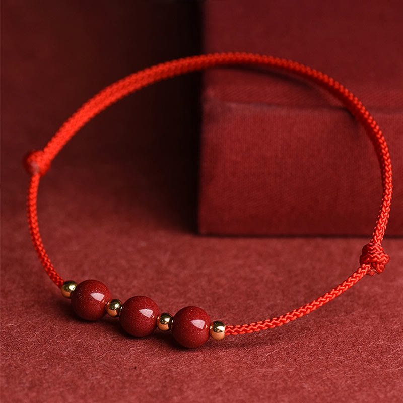Zinnoberarmband und Fußkettchen mit Glücksbringerschnur