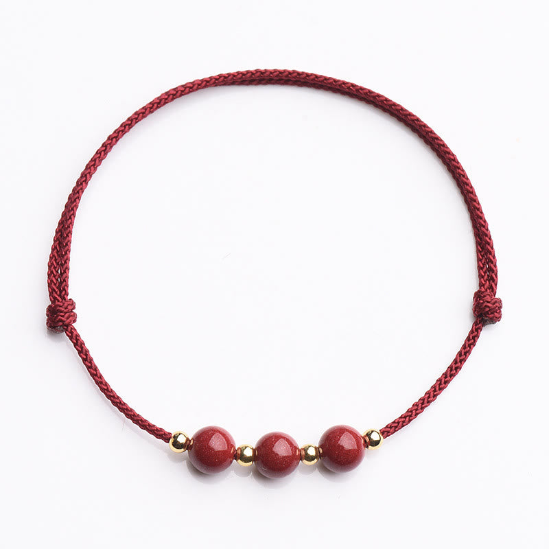 Zinnoberarmband und Fußkettchen mit Glücksbringerschnur