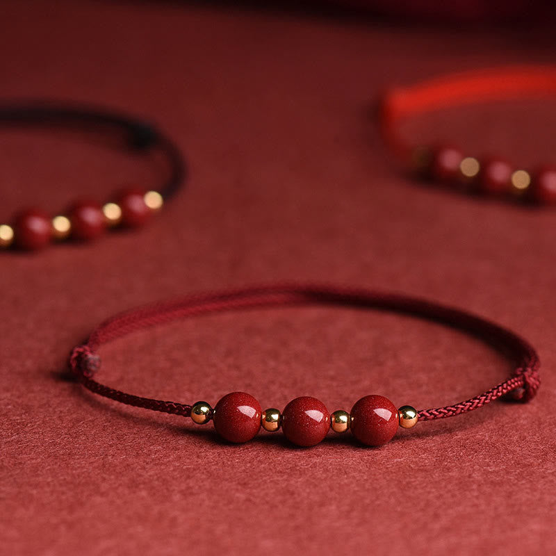 Zinnoberarmband und Fußkettchen mit Glücksbringerschnur