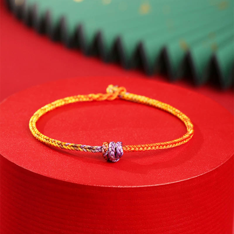 Buntes lila-goldrotes geflochtenes Seilarmband für Balance