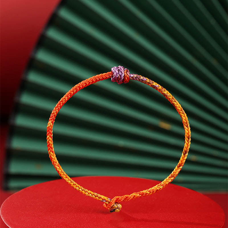 Buntes lila-goldrotes geflochtenes Seilarmband für Balance