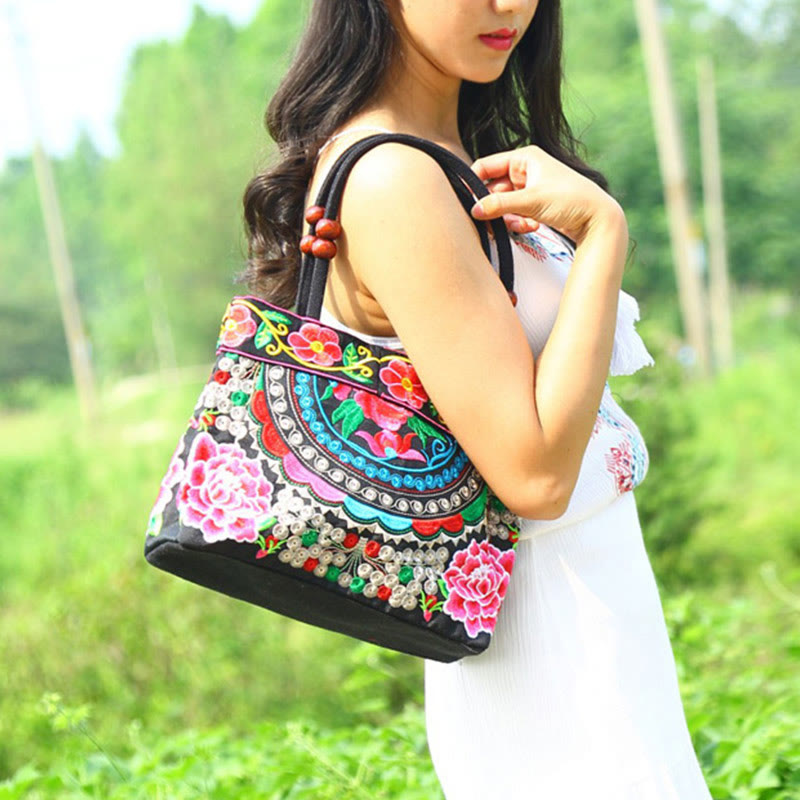 Doppelseitig bestickte Handtasche aus Baumwoll-Canvas mit Wohlstandssymbolen