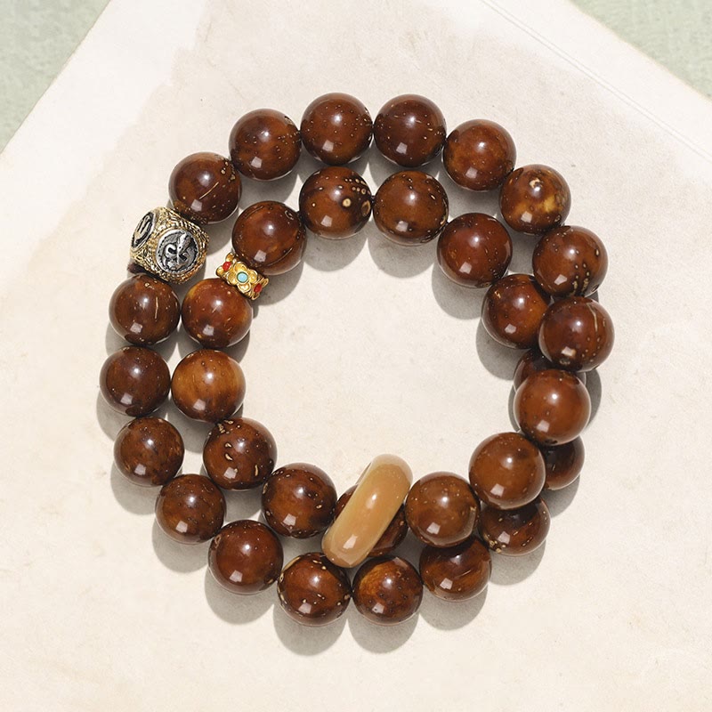 Doppelt gewickeltes spirituelles Armband mit Rattenreichtum und Bodhi-Samen in Lila und Gold