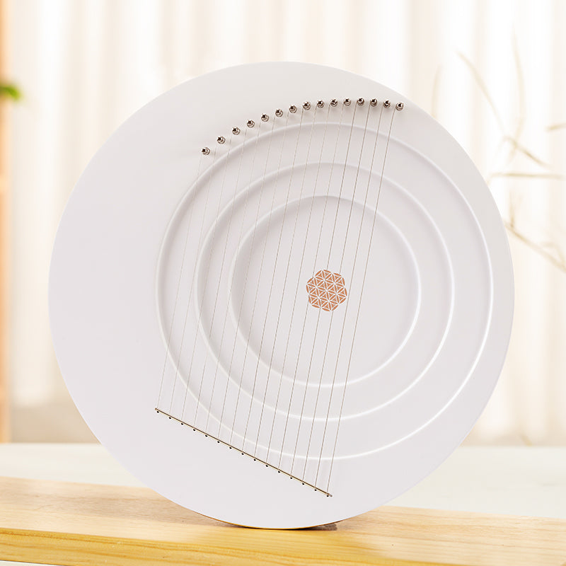 Circular white Full Moon Lyre Harp with metallic strings and decorative center design