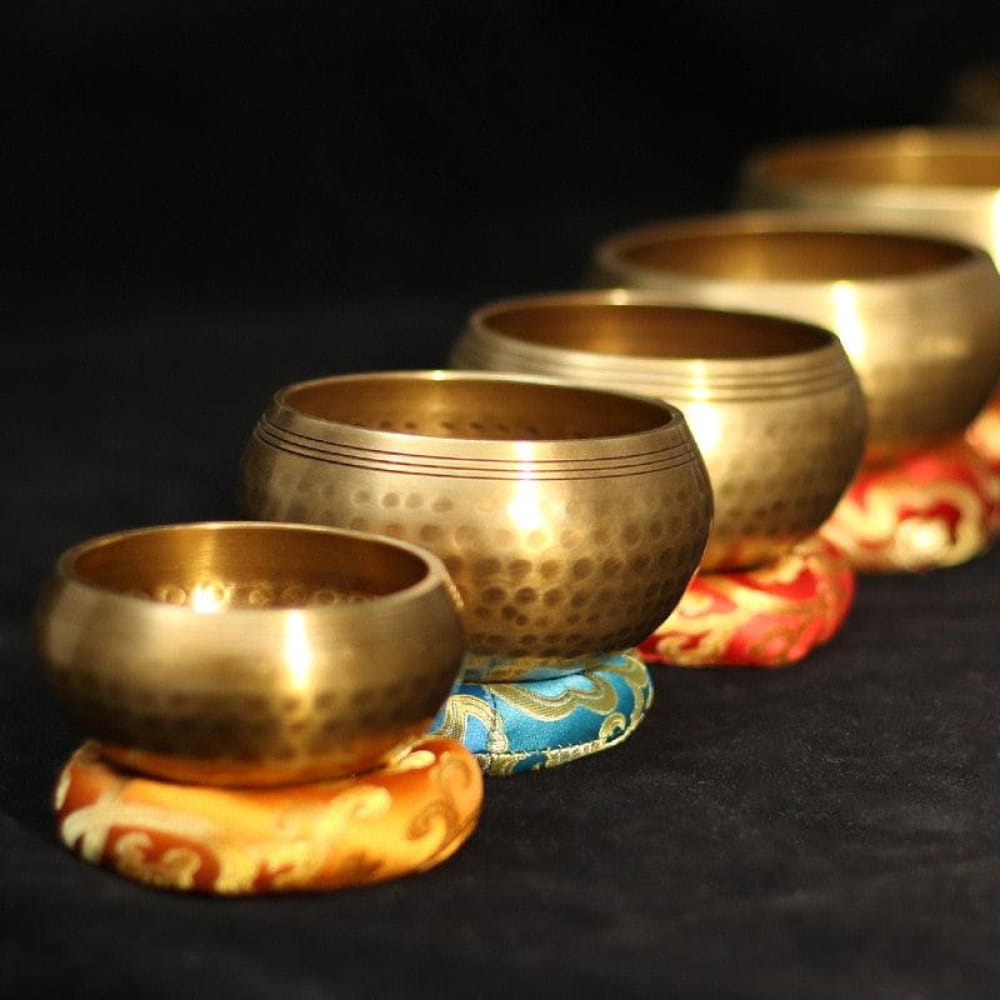 Tibetan singing bowls on decorative cushions for meditation and relaxation