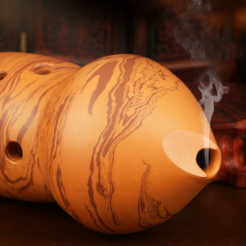 Handmade Ceramic Xun Flute with marbled pot and smoke, showcasing traditional craftsmanship