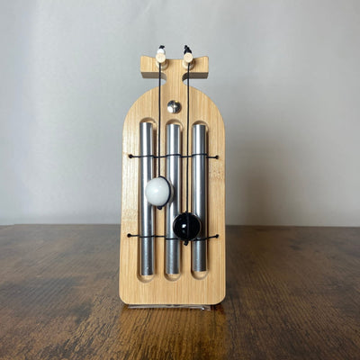 Wooden skateboard-shaped wall chime with metal tubes for cleansing and manifestation