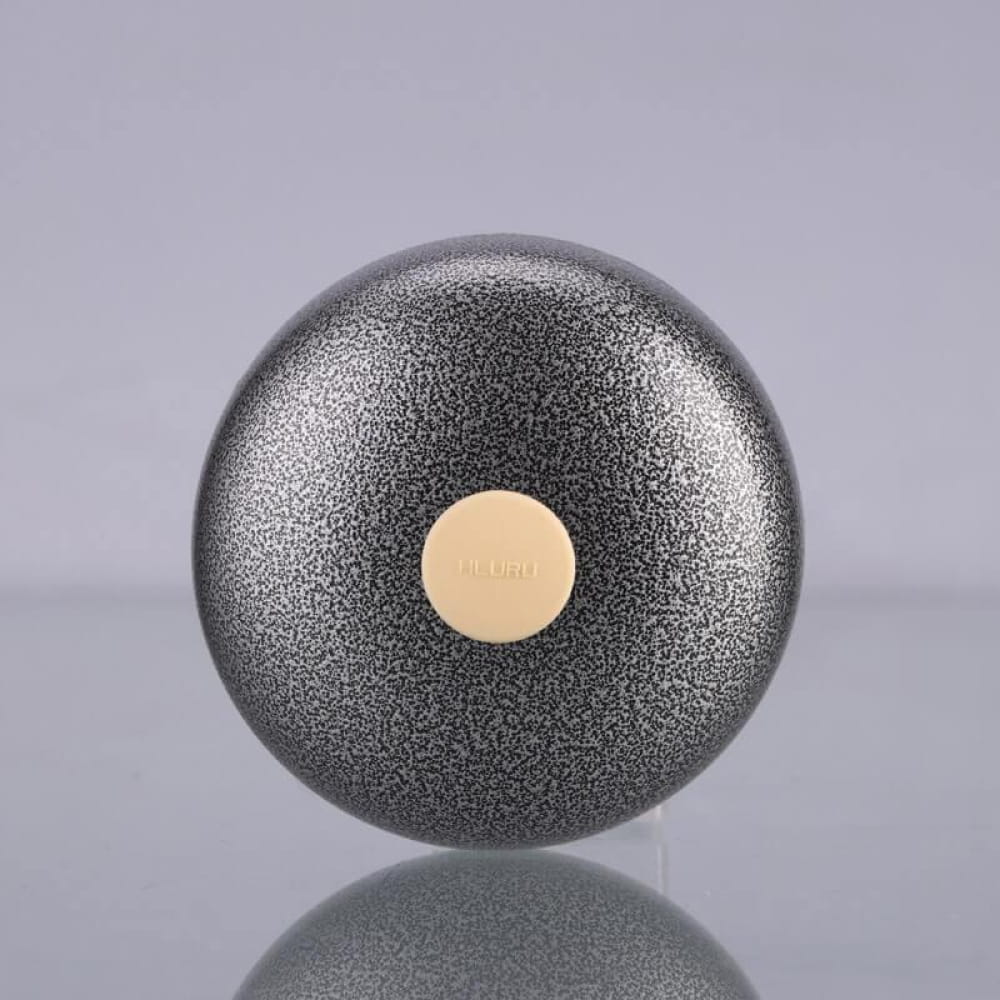 Metallic black sphere with beige dot on Mini Titanium Steel Tongue Drum A5 Pocket Drum