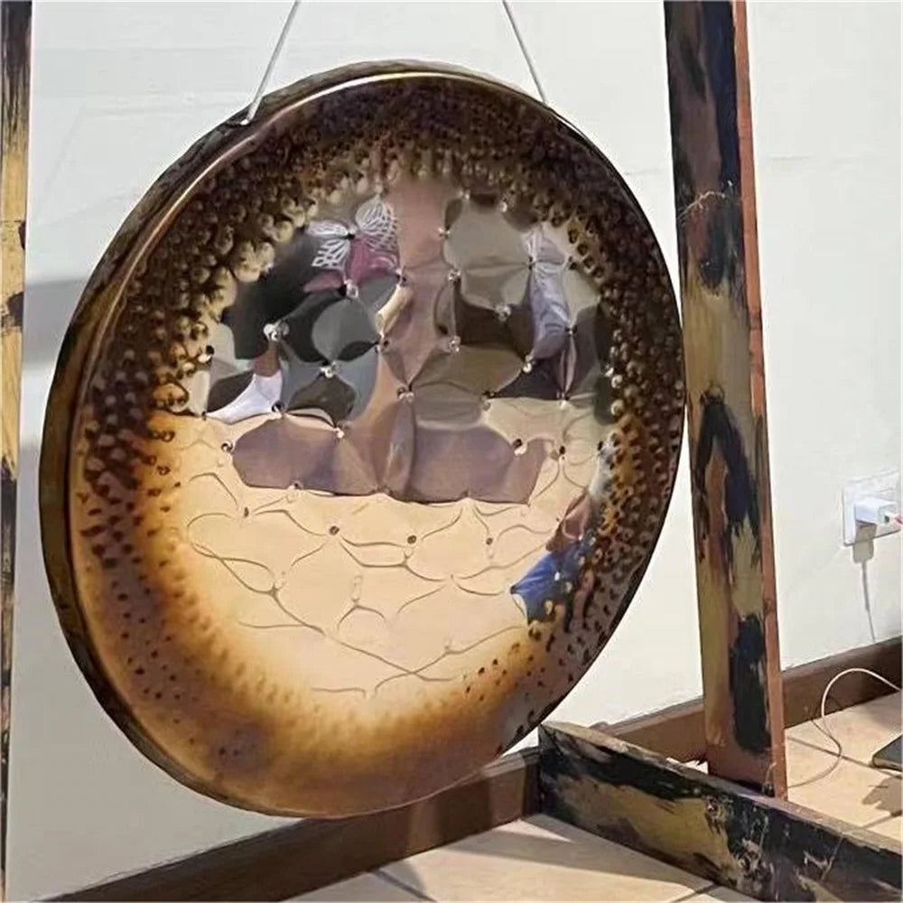 Decorative metal disc with crackled brown-gold finish and bird designs for Mirror Chau Gong