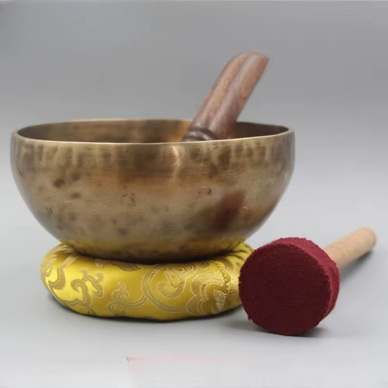 Tibetan Singing Bowl on yellow cushion with striker mallet, Nepal Handmade product