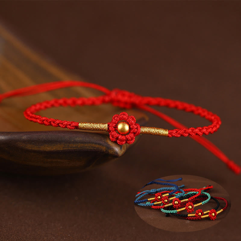 Rotes Schutzarmband mit goldener Blume