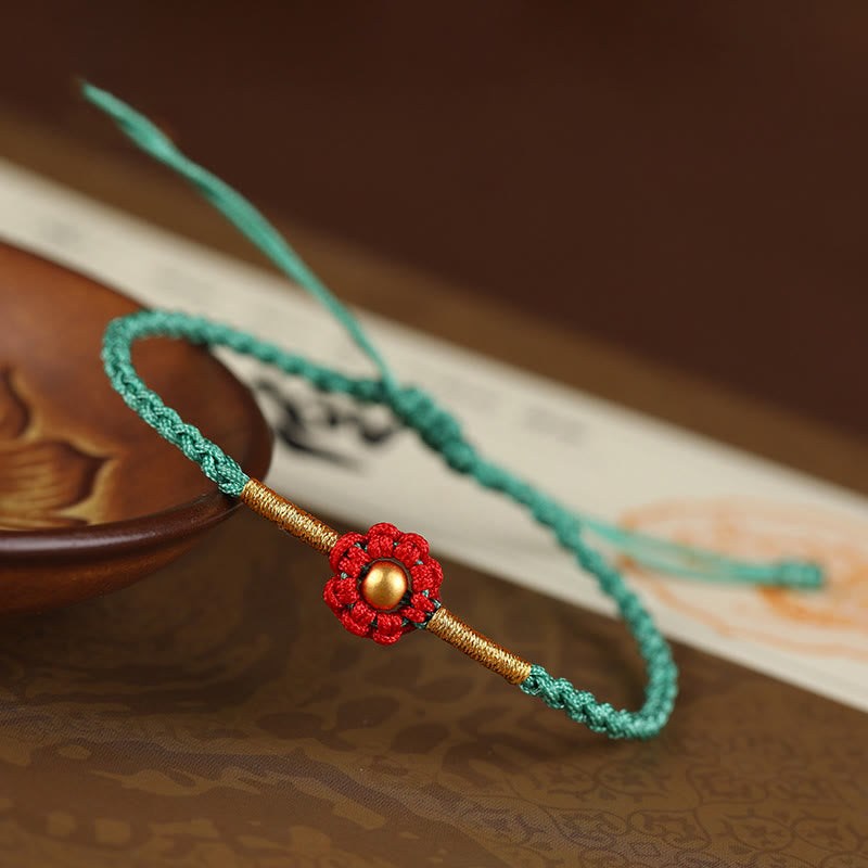 Rotes Schutzarmband mit goldener Blume