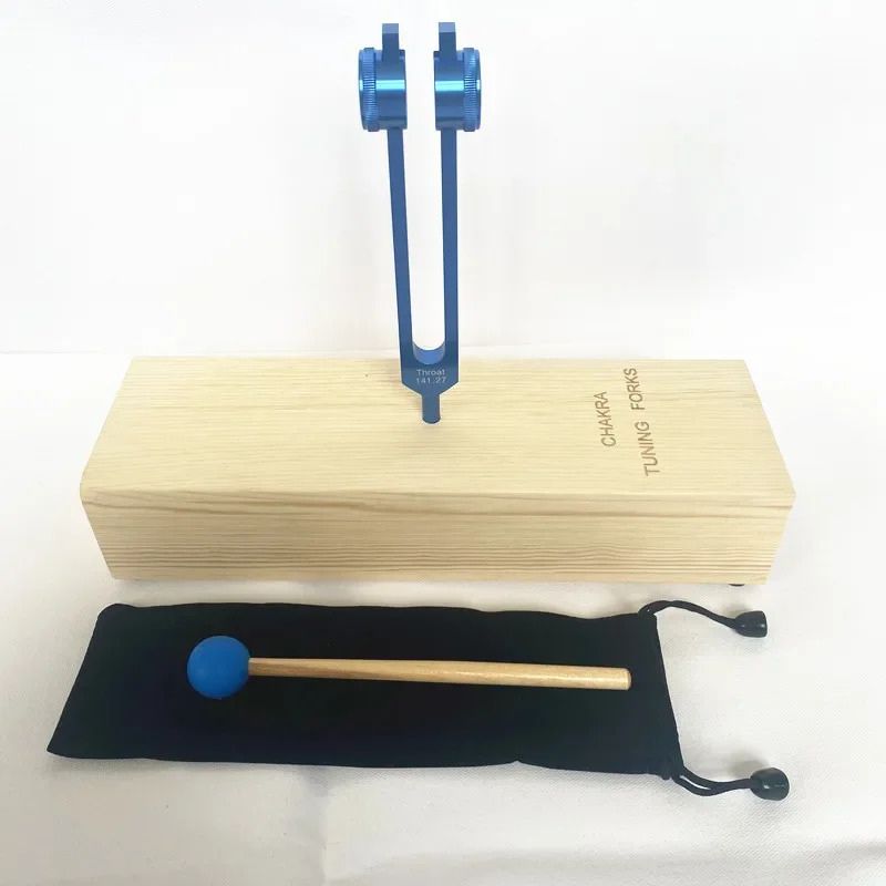 Blue tuning fork with wooden base and mallet for Throat Chakra Healing at 141.27 Hz