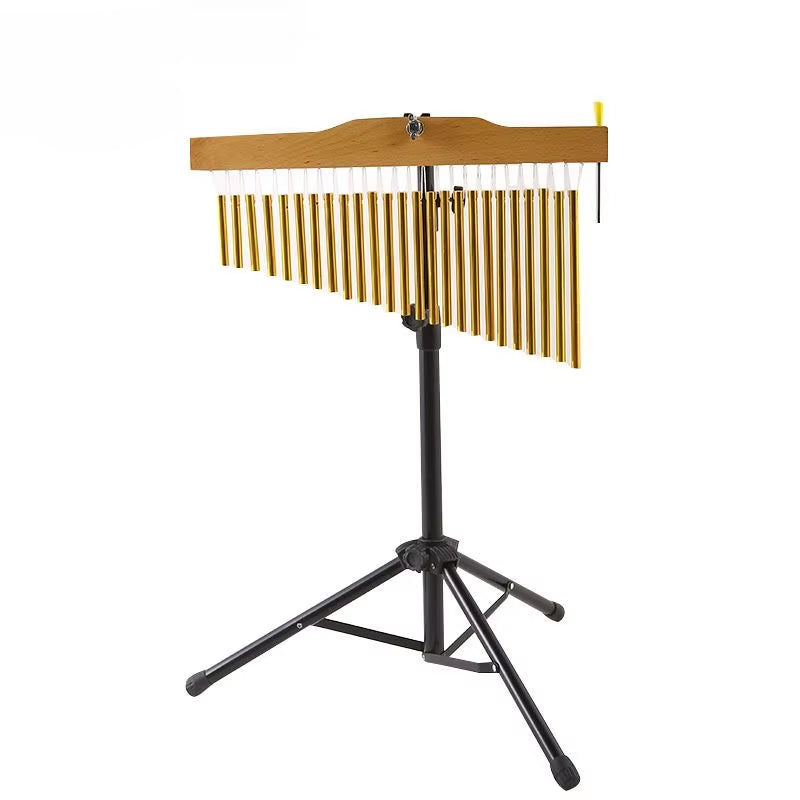 Gold-toned bar chimes on black tripod stand for yoga and meditation sessions