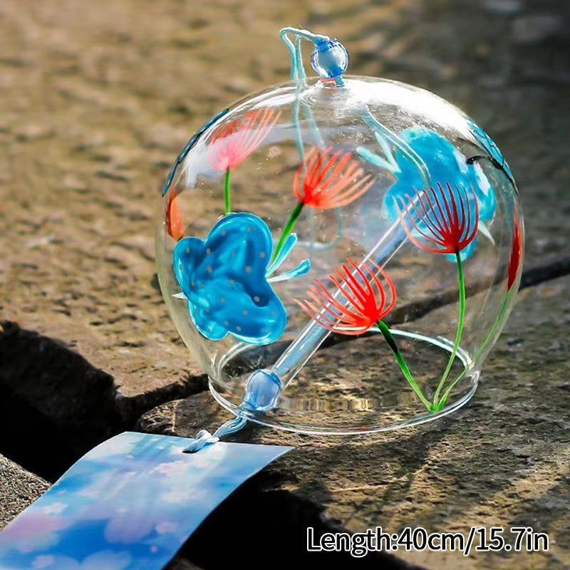 Glass wind chime featuring blue and red floral designs in a clear sphere ornament