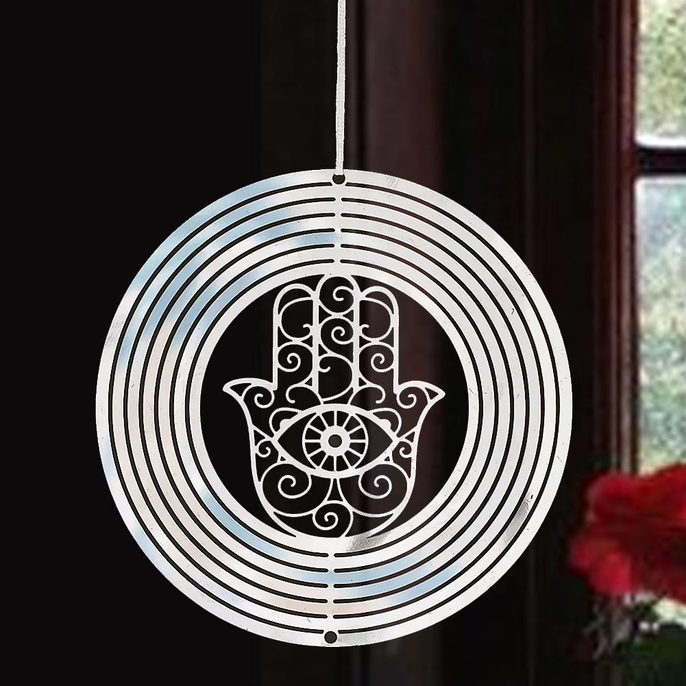 White circular wind spinner with Hamsa hand design, swirls, and central eye motif