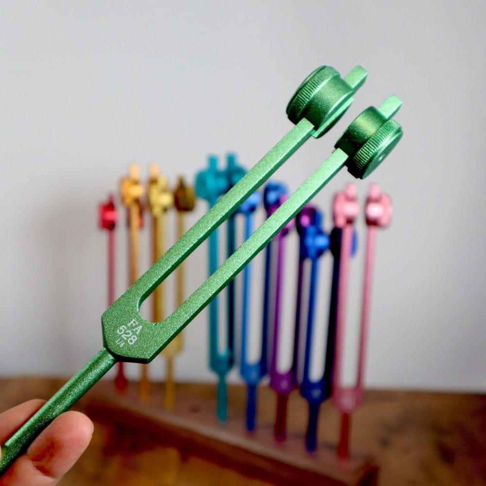 Green metallic 528 Hz Solfeggio tuning fork with two prongs for healing therapy