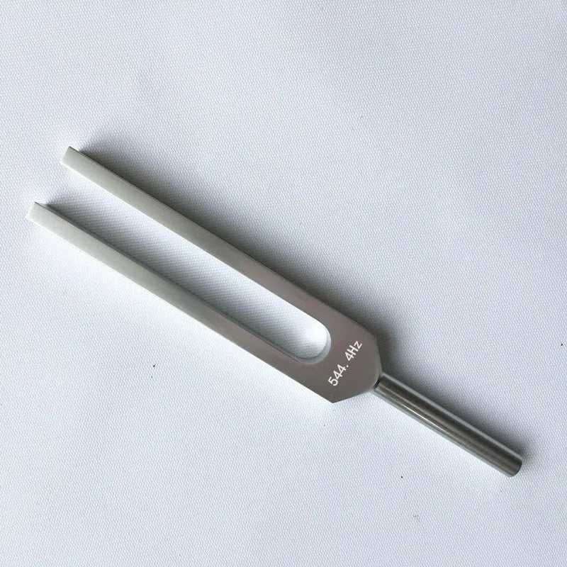 Metal tuning fork with white prongs for 544.4 Hz Ultra OM Healing therapy