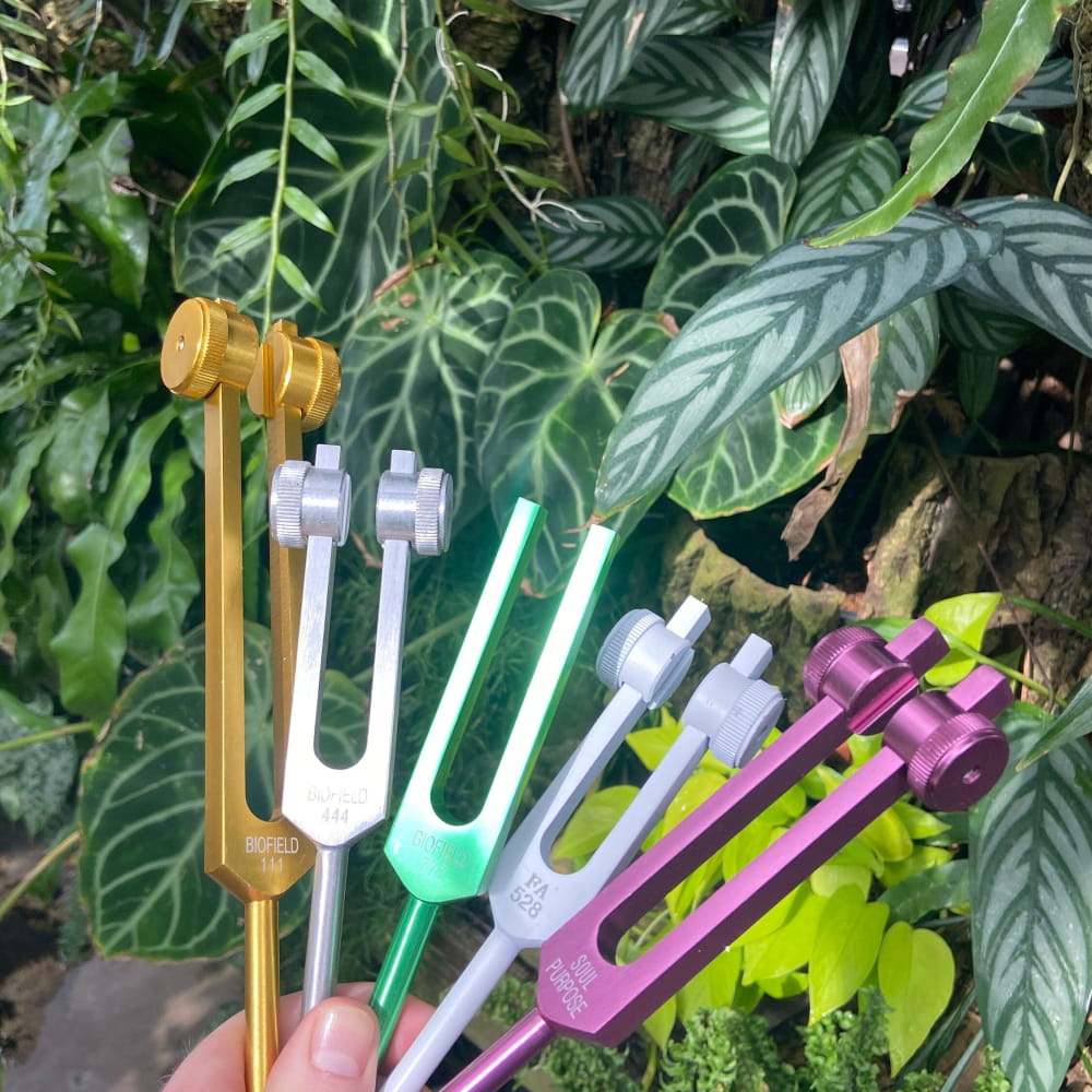 Colorful tuning forks in a fan pattern for healing and manifestation, 528 Hz and more