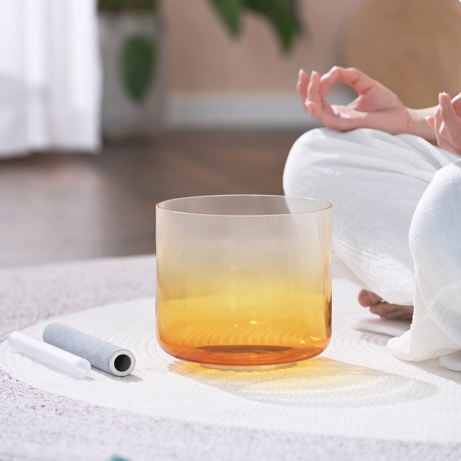 Glass with yellow-orange gradient beverage featured with Quartz Crystal Singing Bowl